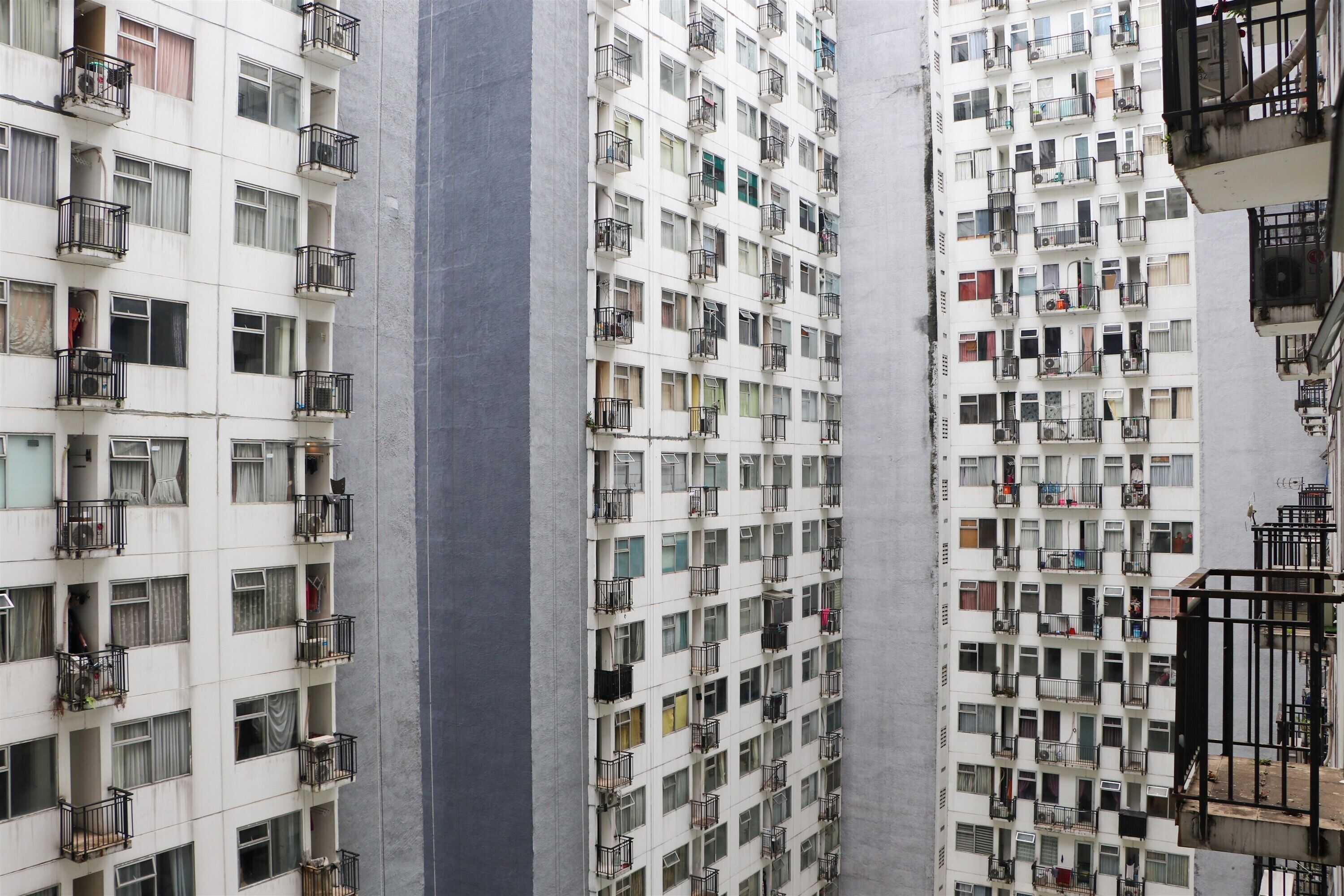 Um edifício residencial alto, com várias varandas, janelas amplas e um design arquitetônico moderno.
