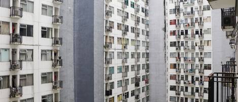 Um edifício residencial alto, com várias varandas, janelas amplas e um design arquitetônico moderno.