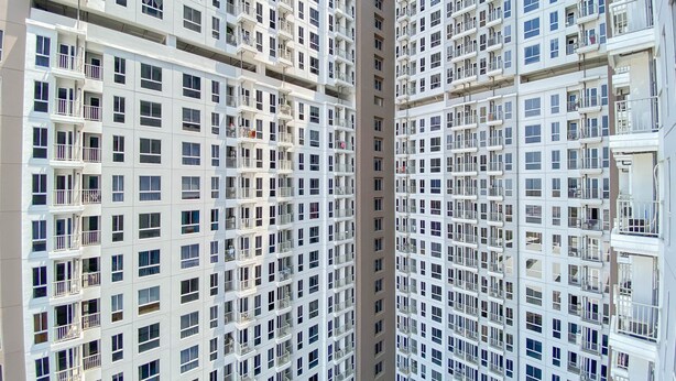 A high-rise residential building with multiple balconies and a uniform architectural design. - Good Price And Homey Studio Tokyo Riverside Pik 2 Apartment (Teluknaga)
