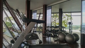 A gym with treadmills, dumbbells, and exercise balls. - Brand New And Good Simply 1Br At Uttara The Icon Apartment (Depok)