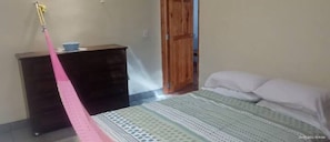 Cozy retreat with a single bed, wardrobe, and ample space for relaxation.