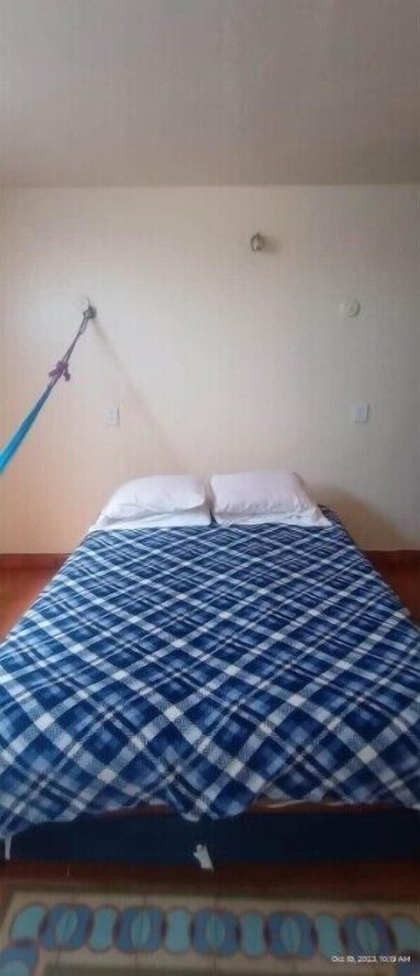 Cozy retreat with a single bed and a comfortable bedspread.