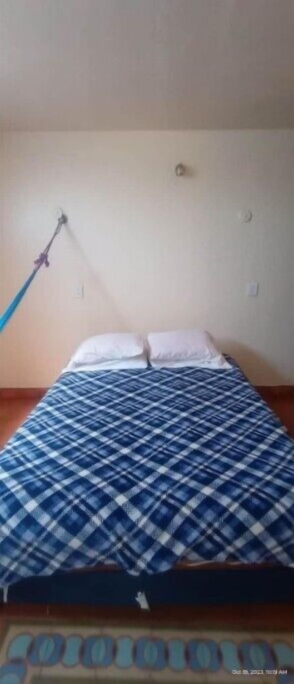 Cozy retreat with a single bed and a comfortable bedspread.
