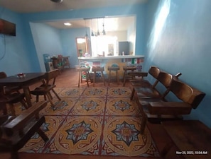 Enjoy meals in this cozy dining area with a traditional rug and comfortable seating.