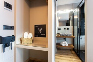 Experience a minimalist retreat with a neatly organized space, glass partition, and charging station.