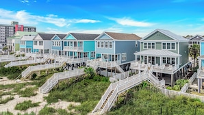 A beachfront property with multiple houses connected by wooden walkways. - True beachfront home with stunning views, near Surfside Pier and restaurants (Surfside Beach)