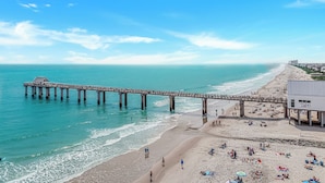 A pier extending into the ocean with a beach and a building on the right. - True beachfront home with stunning views, near Surfside Pier and restaurants (Surfside Beach)