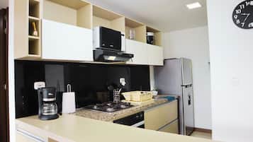 Fridge, microwave, coffee/tea maker, cookware/dishes/utensils