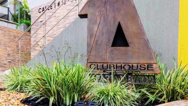 A building with a large 'A' sign and the words 'CLUBHOUSE' on a wall.
