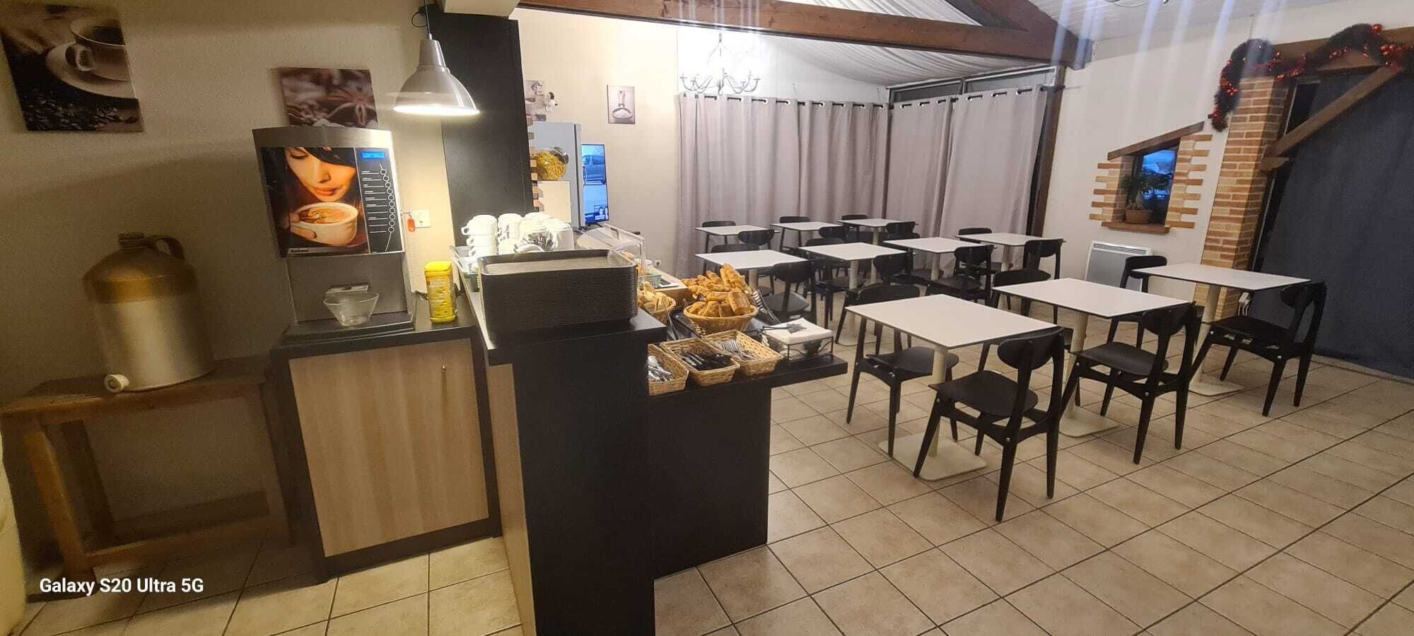 A cafe with a counter, tables, chairs, and a tiled floor.