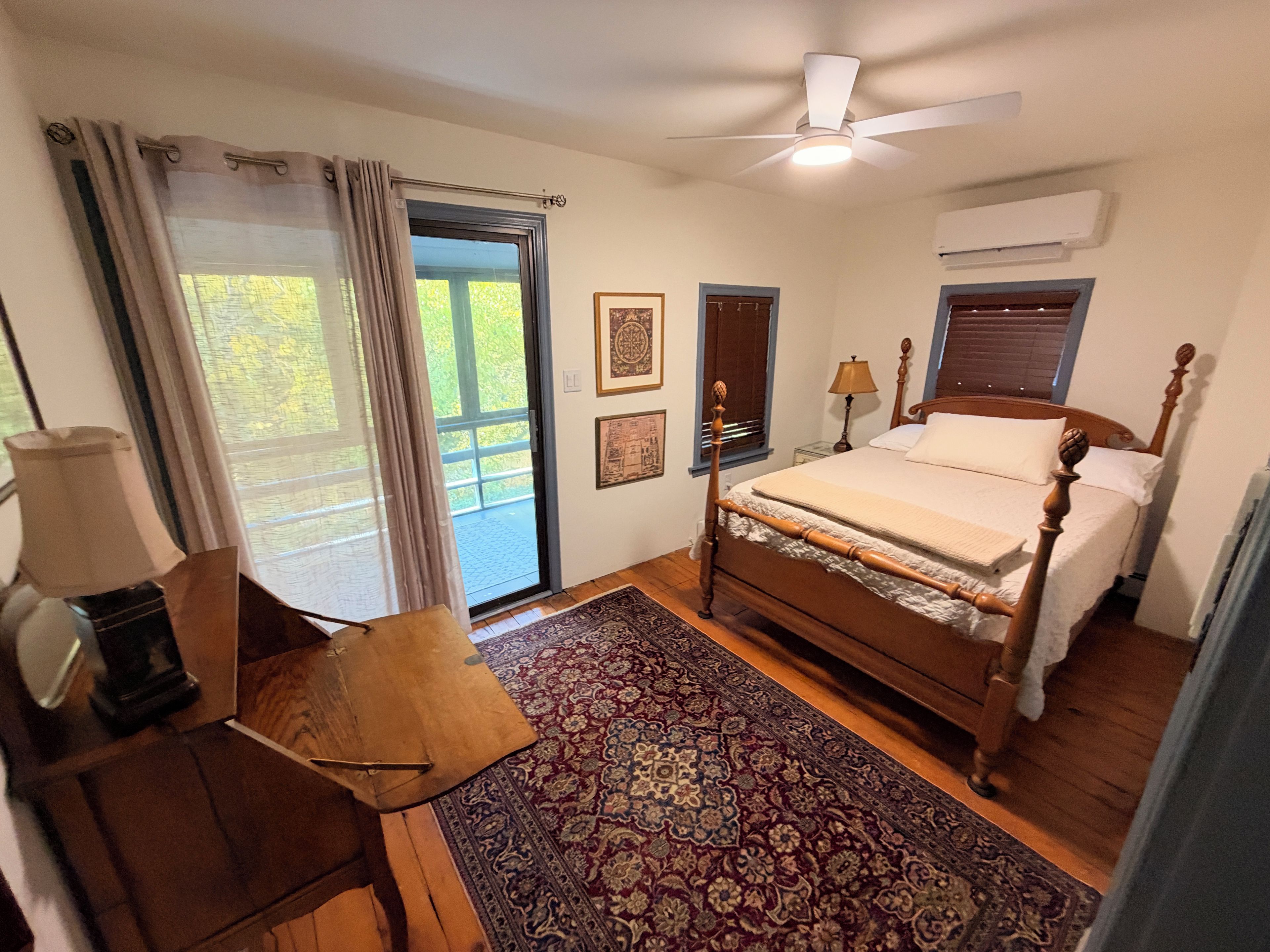 Bedroom with four-poster queen and a door to the screened porch