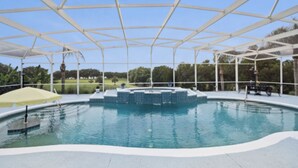 A covered swimming pool with a white roof and a small waterfall feature in the center. - Lakefront Guesthouse on 230 Acres - Very Private - Connect with Nature in style! (Umatilla)