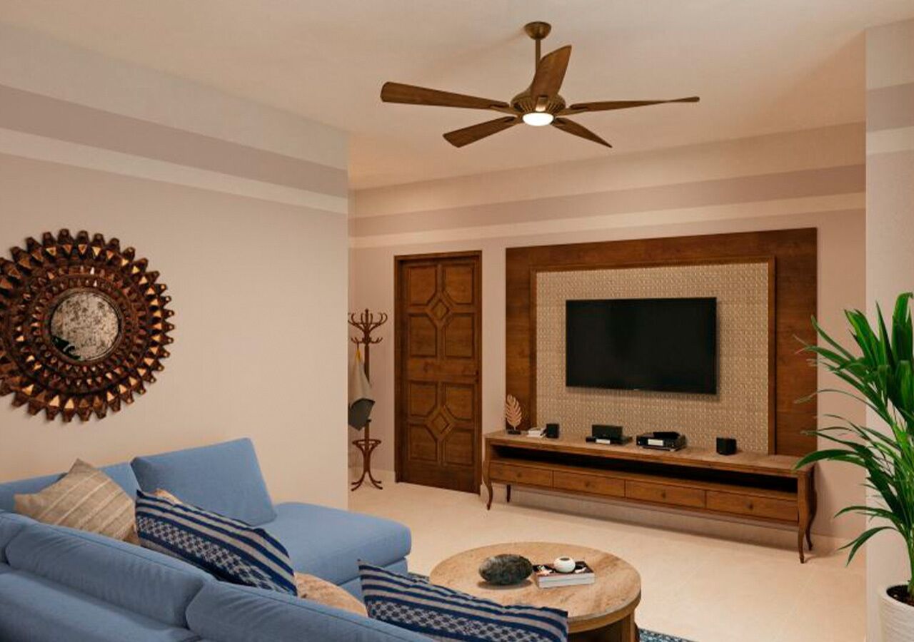 A living room with a blue sofa, a coffee table, a TV on a wooden stand, a ceiling fan, and a decorative wall piece.