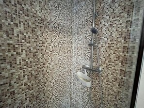 A shower with a tiled wall and a handheld showerhead. - Vila Mena by Trip2Portugal (Guarda)