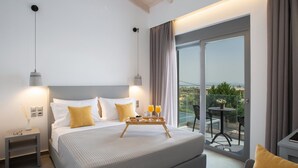 A modern hotel room with a large bed, bedside lamps, a tray with breakfast, and a balcony with a table and chairs. - Aloft Luxury Villas Lefkada - Heated Pool (Lefkada)