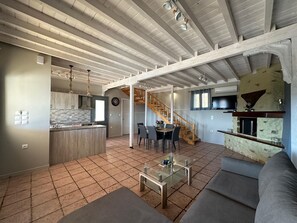 A spacious living area with a kitchen, dining area, and a staircase leading to an upper level. - Eris Villa - Amazing View In Lefkada (Lefkada)