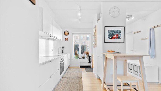 A modern kitchen with white cabinets, a built-in oven, and a window with a view of the outside. - Awesome home in Nivå with WiFi (Nivå)