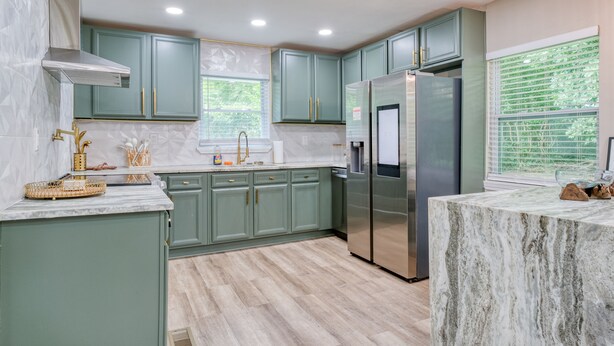 A modern kitchen with green cabinets, a marble countertop, and stainless steel appliances. - Atlanta's East Point charm, just a 13-min drive away from Mercedes-Benz Stadium (East Point)