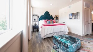 A bedroom with a large bed, a nightstand, a chair, and a window. - Comfort Studio,1 King Bed 207 (Dallas)