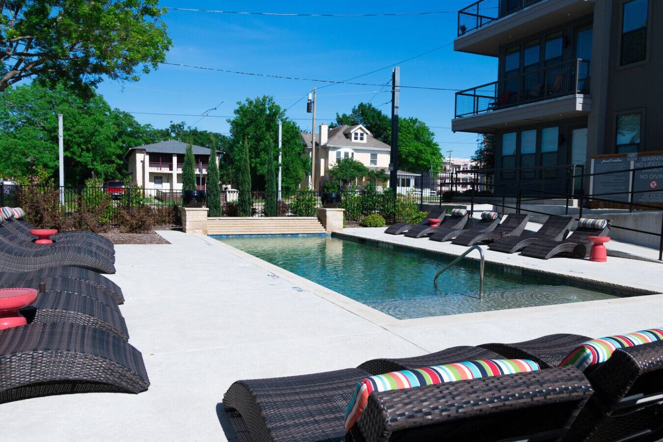 A pool area with lounge chairs and a small pool.
