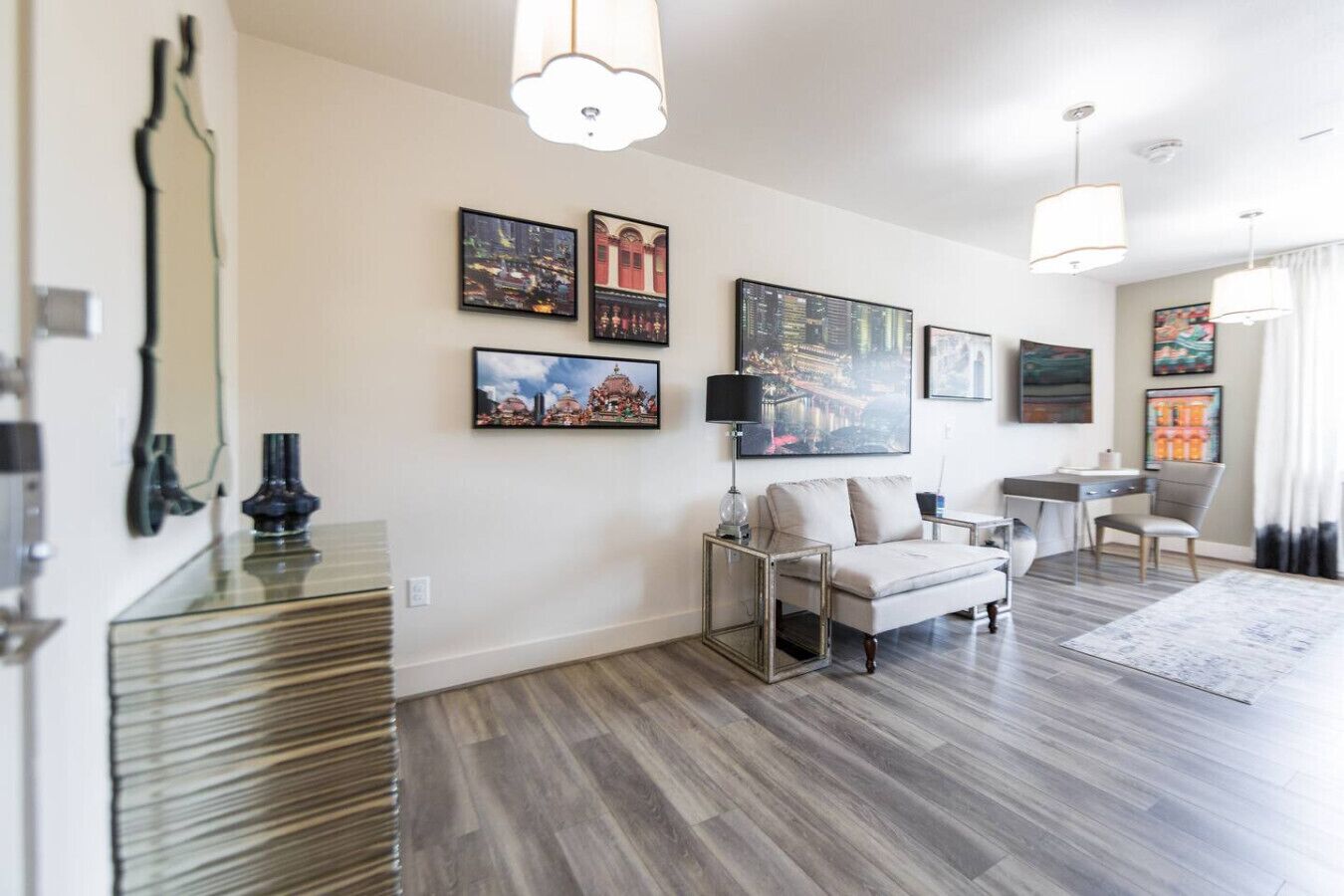 A modern living room with a sofa, coffee table, and artwork on the walls.