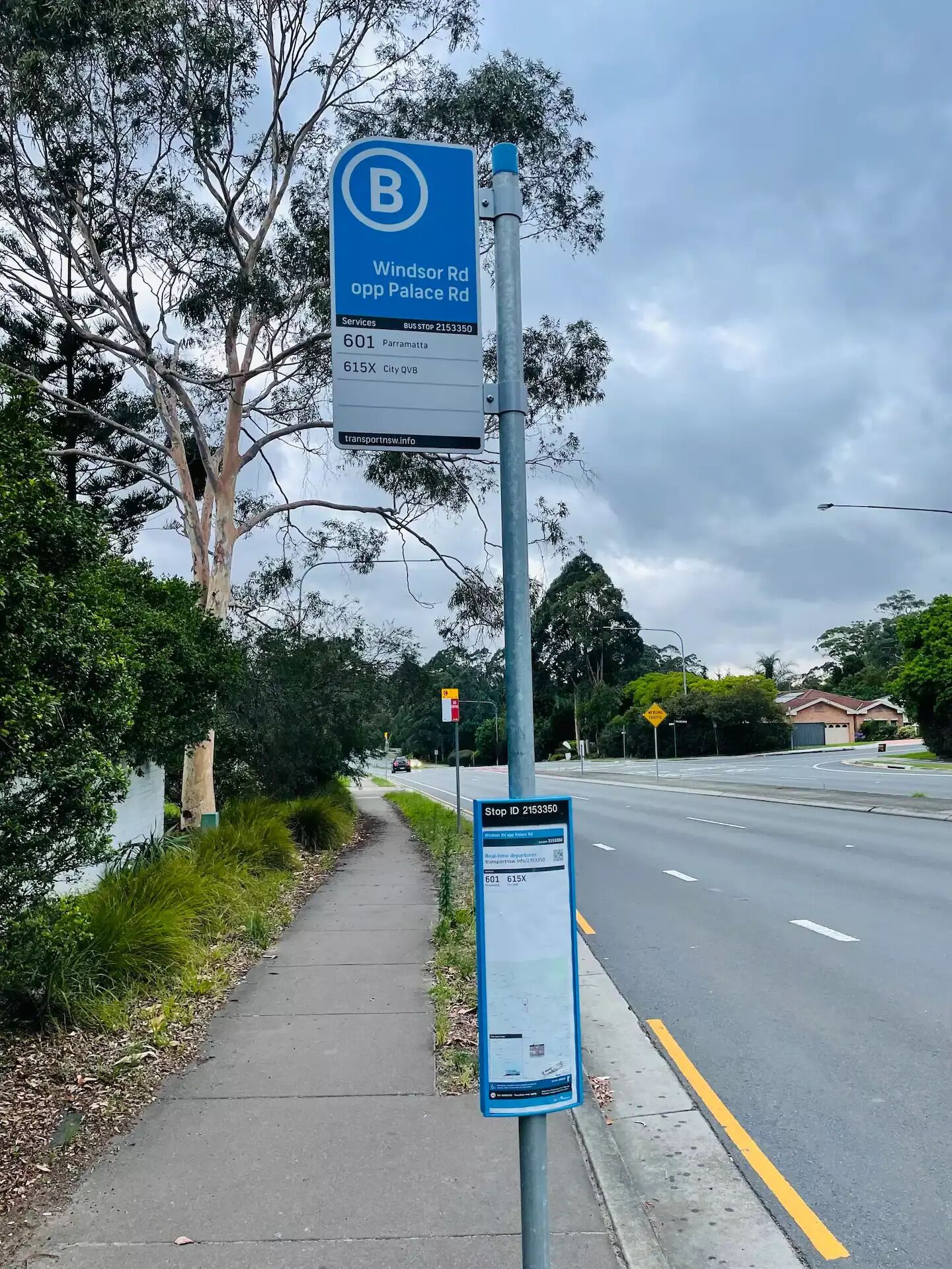 A bus stop sign with Windsor Rd and Palace Rd, bus stop number 2153350, and contact information for transport services.