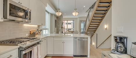 Enjoy cooking in this kitchen with a central island, oven, and stainless steel range.