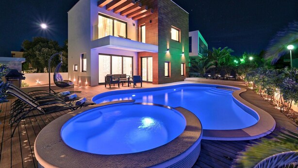 A modern two-story building with a swimming pool and outdoor seating area. - Nice home in Zaton with private swimming pool, can be inside or outside (Zaton)