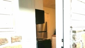 A kitchen with a refrigerator and a microwave. - Magnolia #3 @ Copper Johns Resort (Lakeview)
