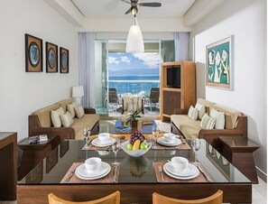 Enjoy a meal for four at the dining table, relax on the comfortable sofas, and take in the ocean view from the large window.