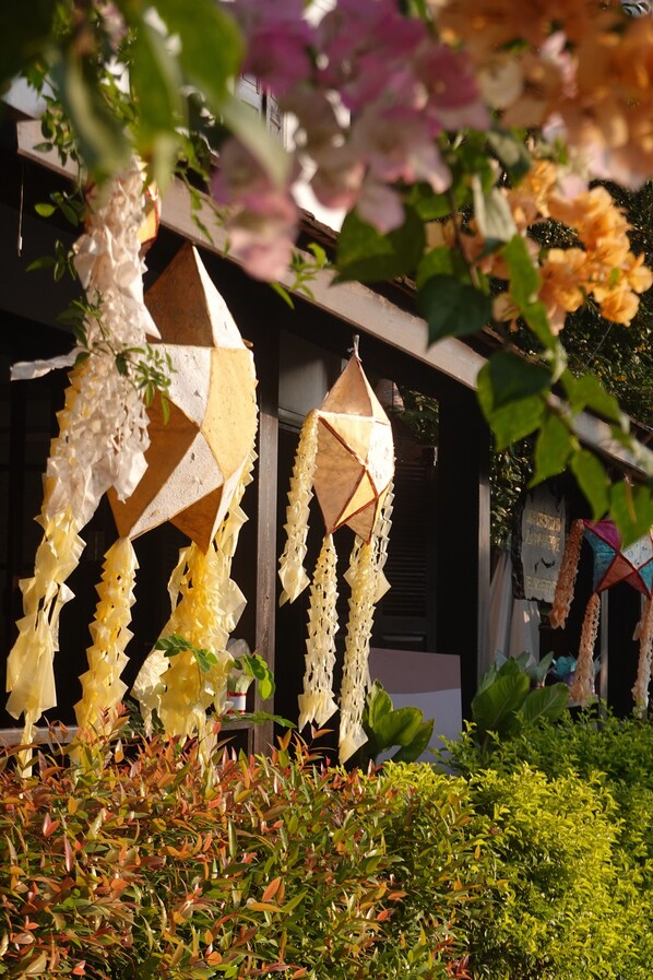 A building with a modern architectural style, featuring a geometric facade and hanging decorative elements.
