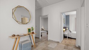 A hallway with a desk, a mirror, and a bed in the background. - Stunning home in Labin - Rabac (Labin - Rabac)