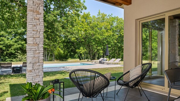 A patio with two black wire chairs, a potted plant, and a lantern. - Stunning home in Labin - Rabac (Labin - Rabac)