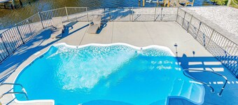 Waterfront home with private pool, hot tub, dock, outdoor areas, & game room