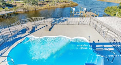 Waterfront home with private pool, hot tub, dock, outdoor areas, & game room