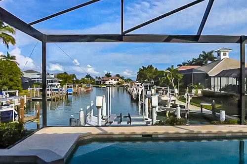 Canal-front home with private pool, pool spa, dock, boat access, grill, gym, W/D