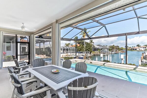 Outdoor dining - Canal-front home with private pool, pool spa, dock, boat access, grill, gym, W/D (Marco Island)