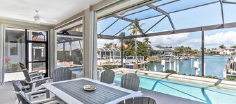 Canal-front home with private pool, pool spa, dock, boat access, grill, gym, W/D