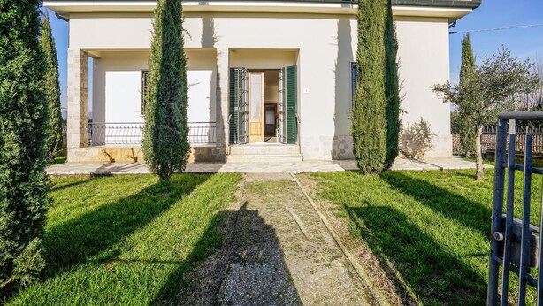 A building with a central entrance, flanked by two tall, narrow trees. - Stunning home in Ponte Buggianese (Ponte Buggianese)