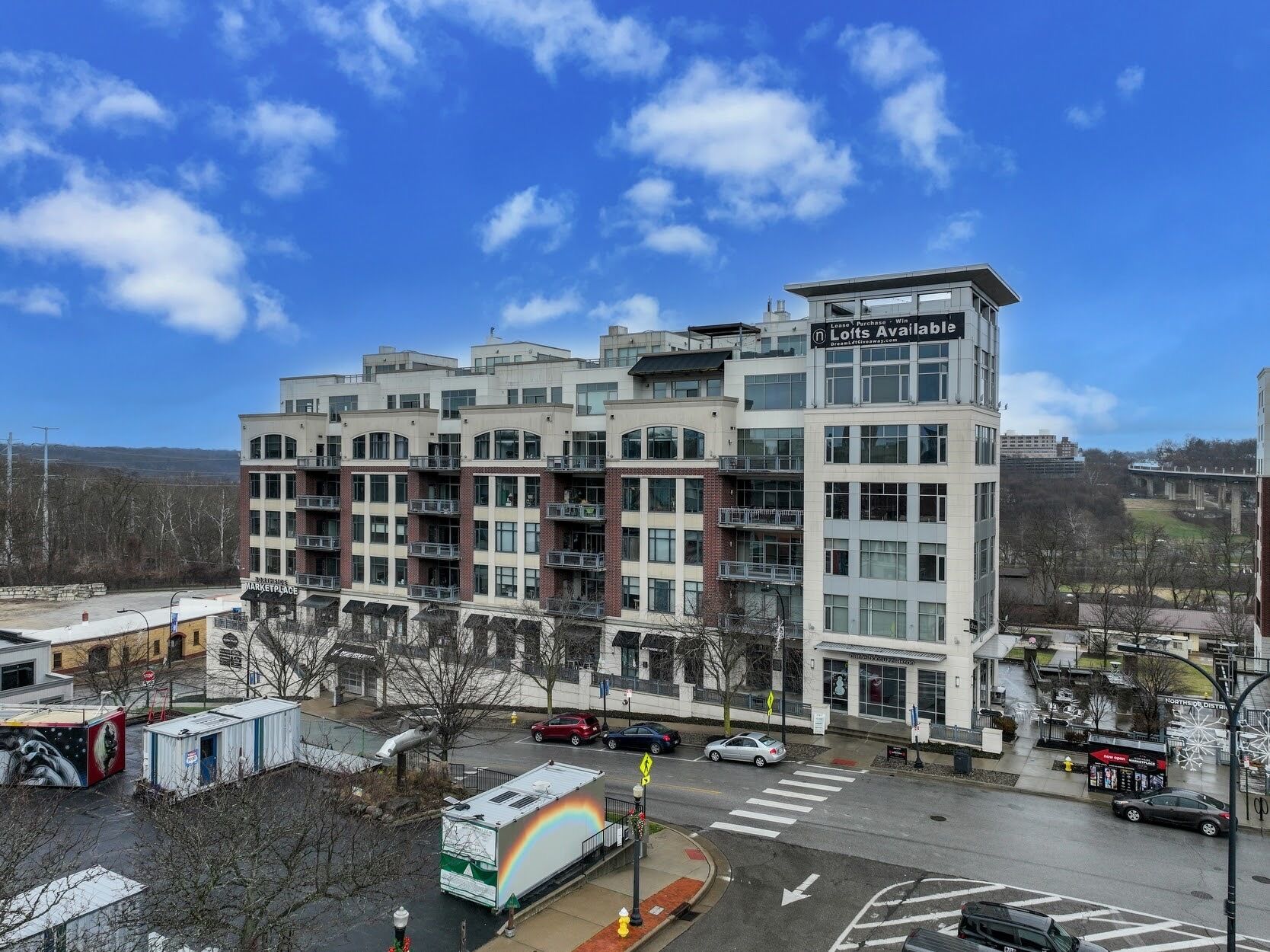 A multi-story building with a sign indicating available lofts for purchase.