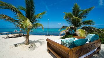 Relax on a sandy shore with a bench and enjoy the tranquil ocean views.