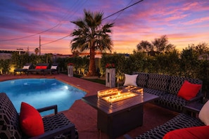 A pool area with a fire feature, outdoor seating, and a palm tree. - Modern Roose-Pool-Spa-Fire Pit-Mins to Old Town! (Scottsdale)