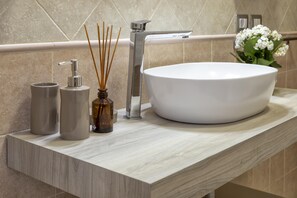 A bathroom with a large white sink, a modern faucet, and a wooden countertop. - Sardinia Re - White Olives (Alghero)