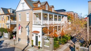 A two-story house with a balcony, a front porch, and a small garden area. - 6C at Saint Philip Square, One Block to King, Classic Charleston Comfort (Charleston)