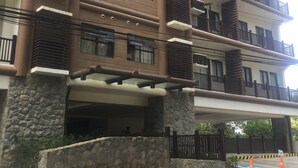 A multi-story building with a stone base and a nameplate reading "BRENTHILL". - Brenthill Condominium (Baguio)