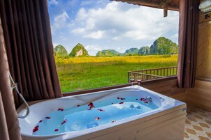 Deep soaking tub, hydromassage showerhead, designer toiletries