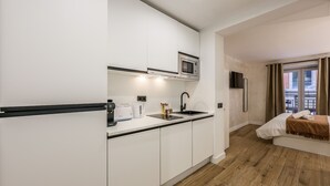 A modern kitchen with white cabinets, a microwave, and a sink. - NEW loft one step away from SOL (P1B) (Madrid)