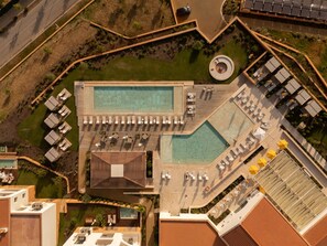 An aerial view of a resort with a large pool, sun loungers, and a separate swimming area. - Viceroy At Ombria Algarve (Loulé)