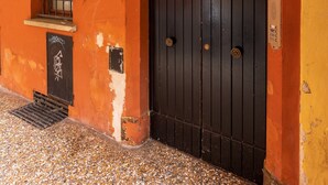 A building with a black door, a window with metal bars, and a number '19' on the wall. - Apartment 'Mirasole House' with Wi-Fi and Air Conditioning (bologna)