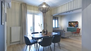 A modern dining area with a wooden table, black chairs, and a unique chandelier. - Urban Luxury in the Heart of Athens (Athens)